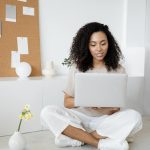Young professional woman scrolling on her laptop: Ever Accountable: How ADHD diagnosis can increase vulnerability to porn addiction